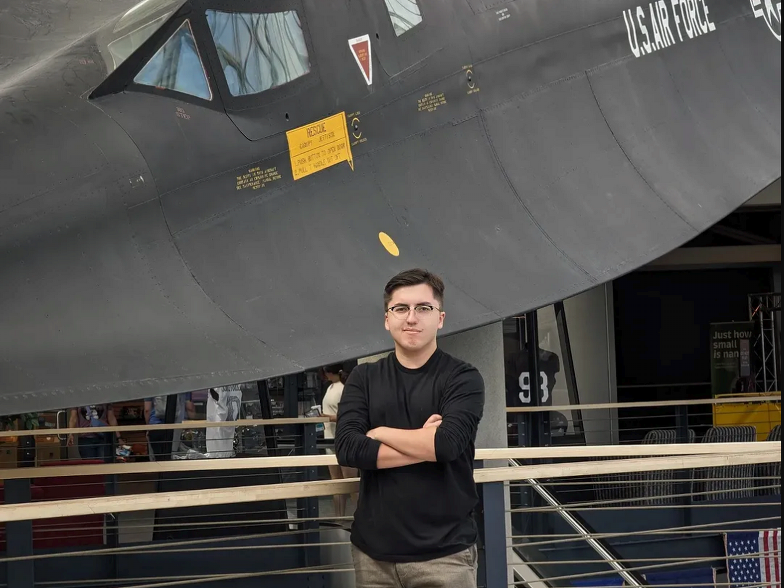 David Krieger standing beneath the nose of a Lockheed SR-71 Blackbird in a museum lobby